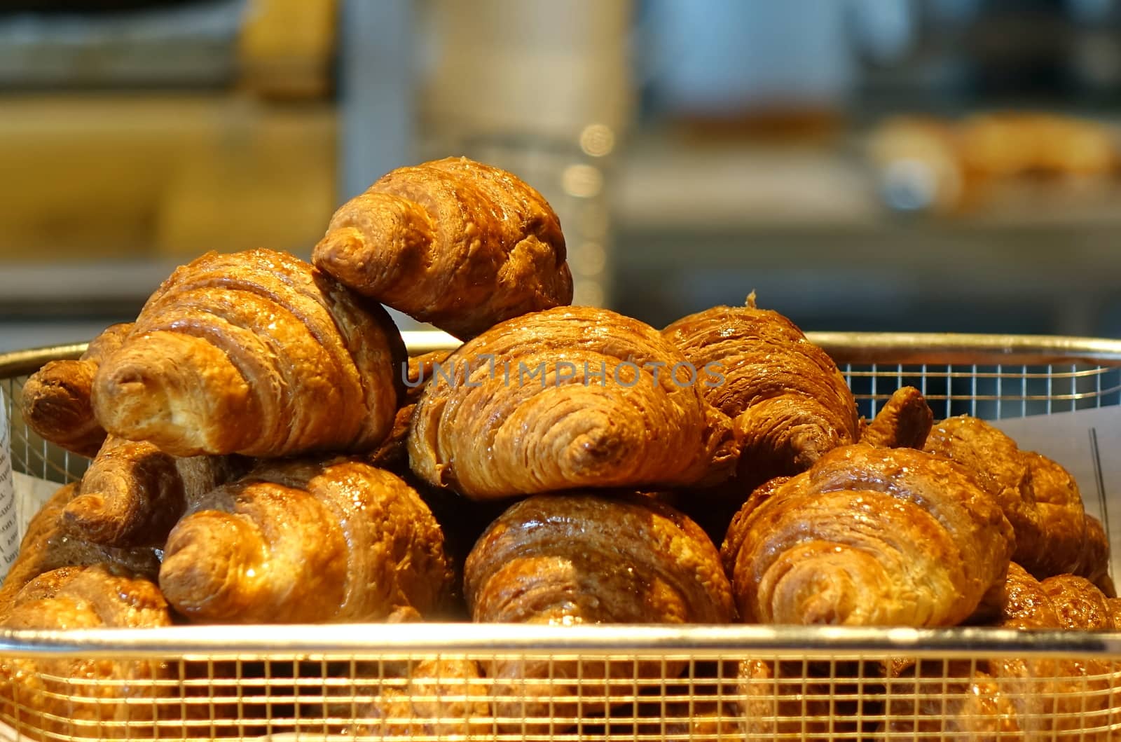 Freshly baked croissant buns in a tray
