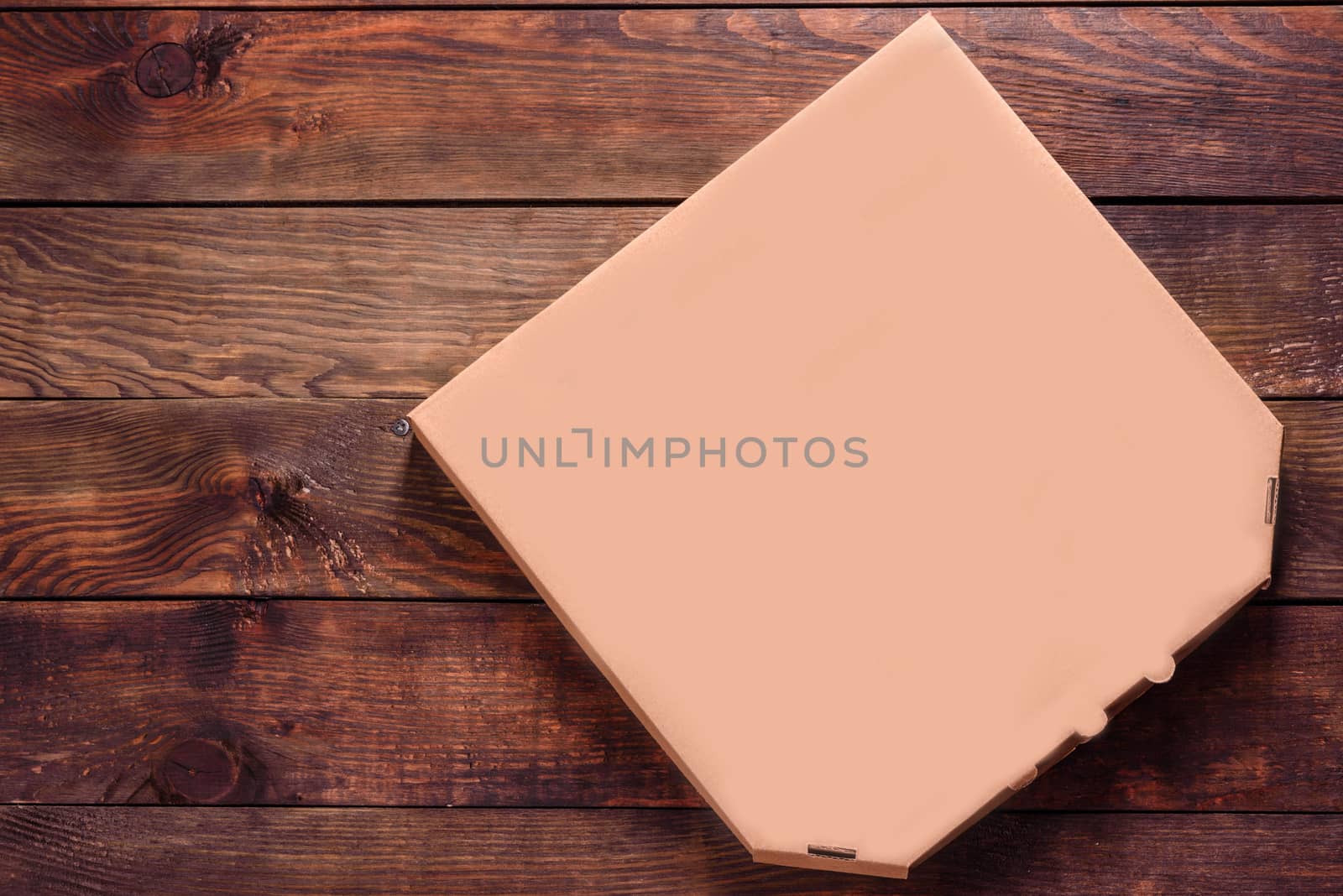 Pizza box Blank Mockup of brown Cardboard for delivery on a wooden background