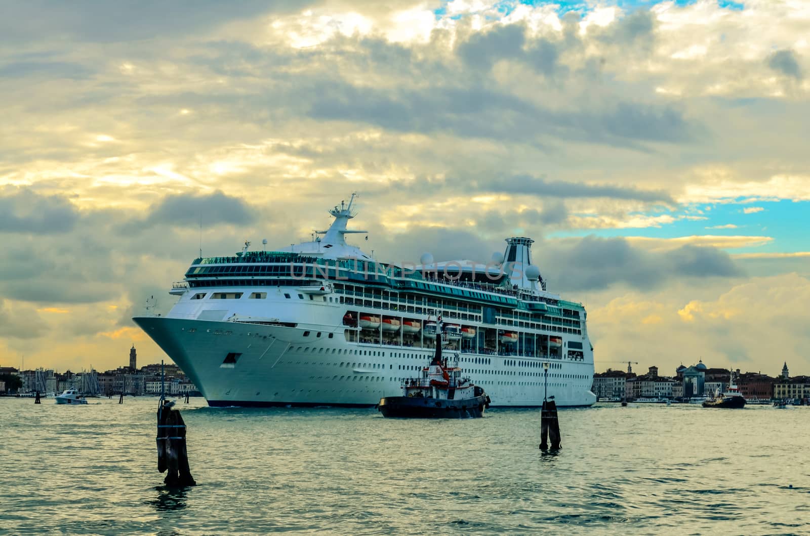 A large beautiful cruise ship leaves the port of Venice, Italy by chernobrovin