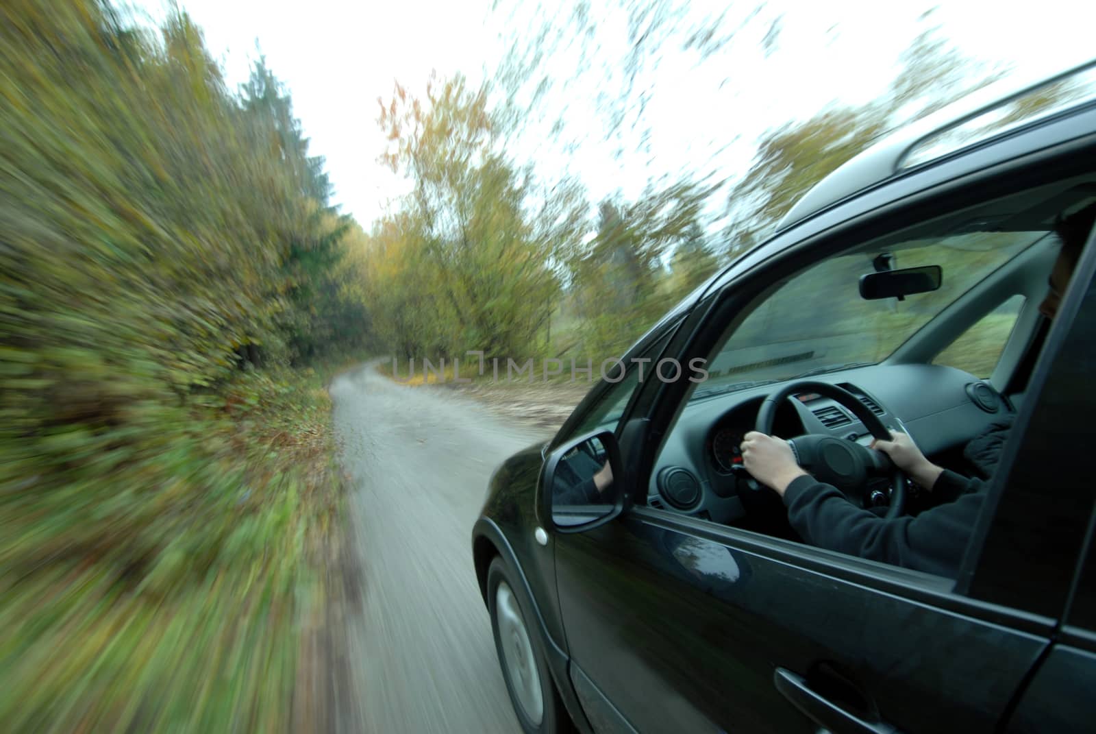 Car driving on country road by aselsa