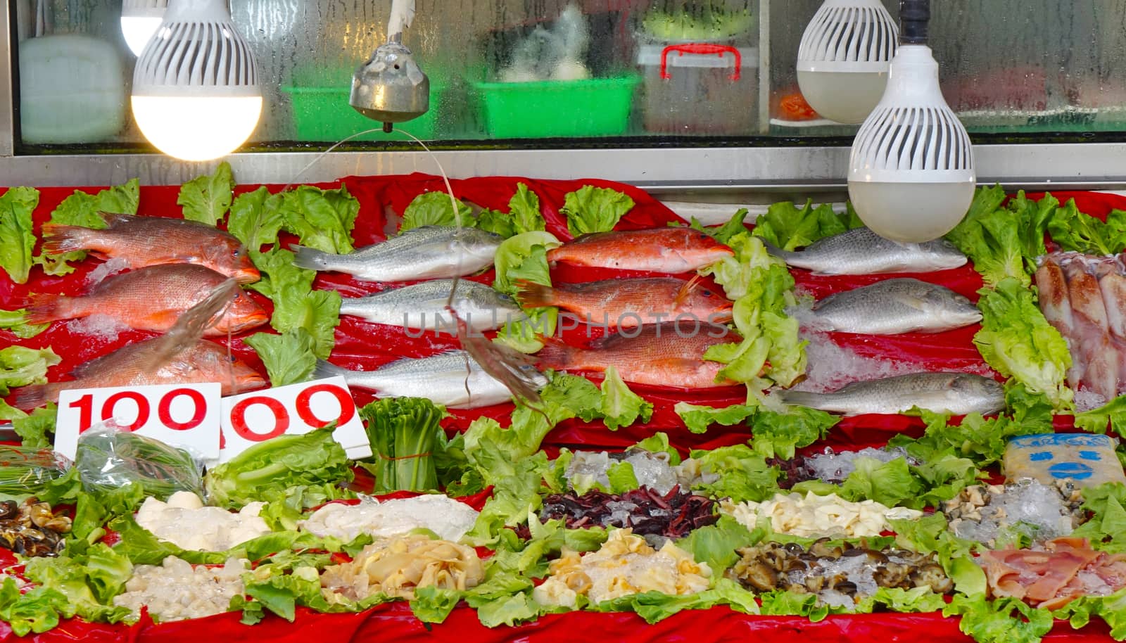 A seafood restaurant displays fresh fish and seafood for customers to choose from
