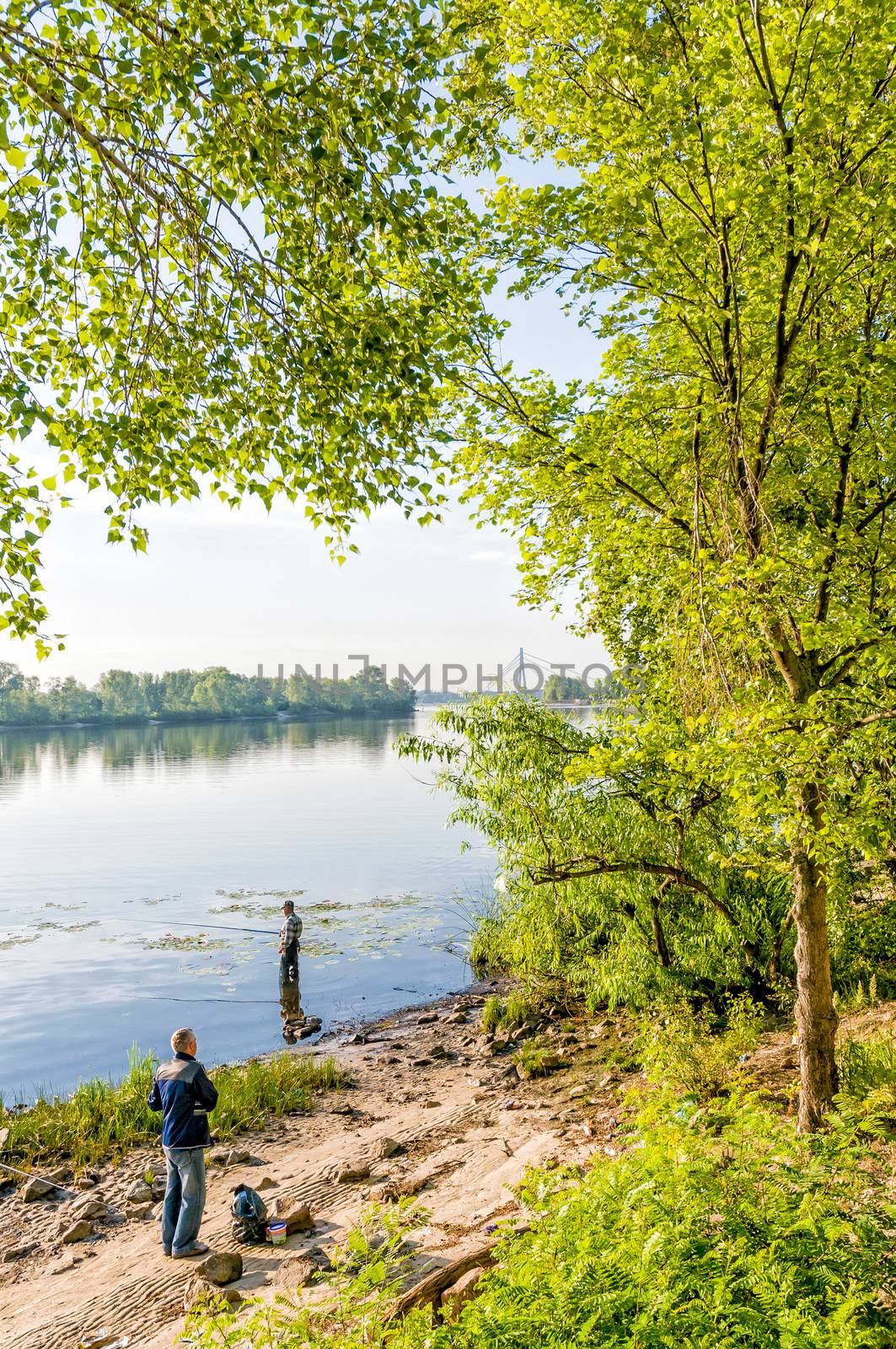 KIEV/UKRAINE - JUNE 20, 2010 - Fishers on the Dnieper River in Kiev, Ukraine, during a nice morning of spring