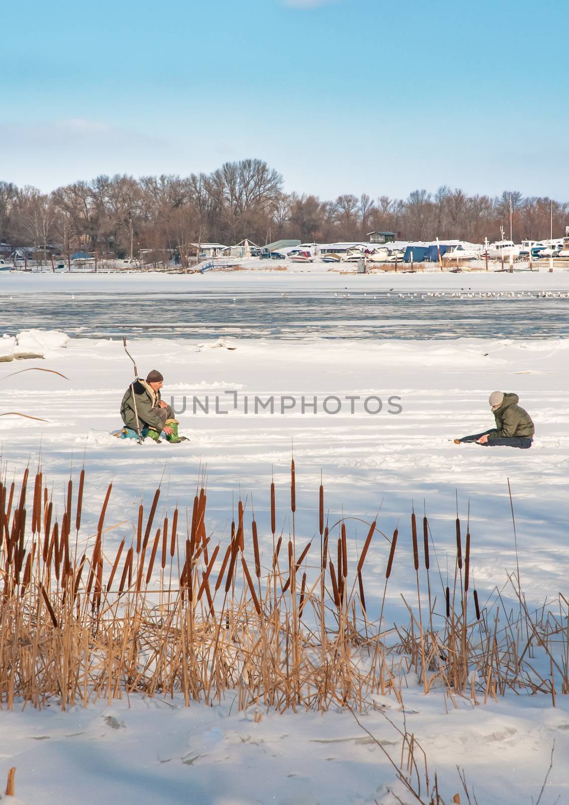 Kiev/Ukraine - February 21, 2012 - Fishermen on the frozen Dnieper in the Obolon district of Kiev, Ukraine, during a cold winter