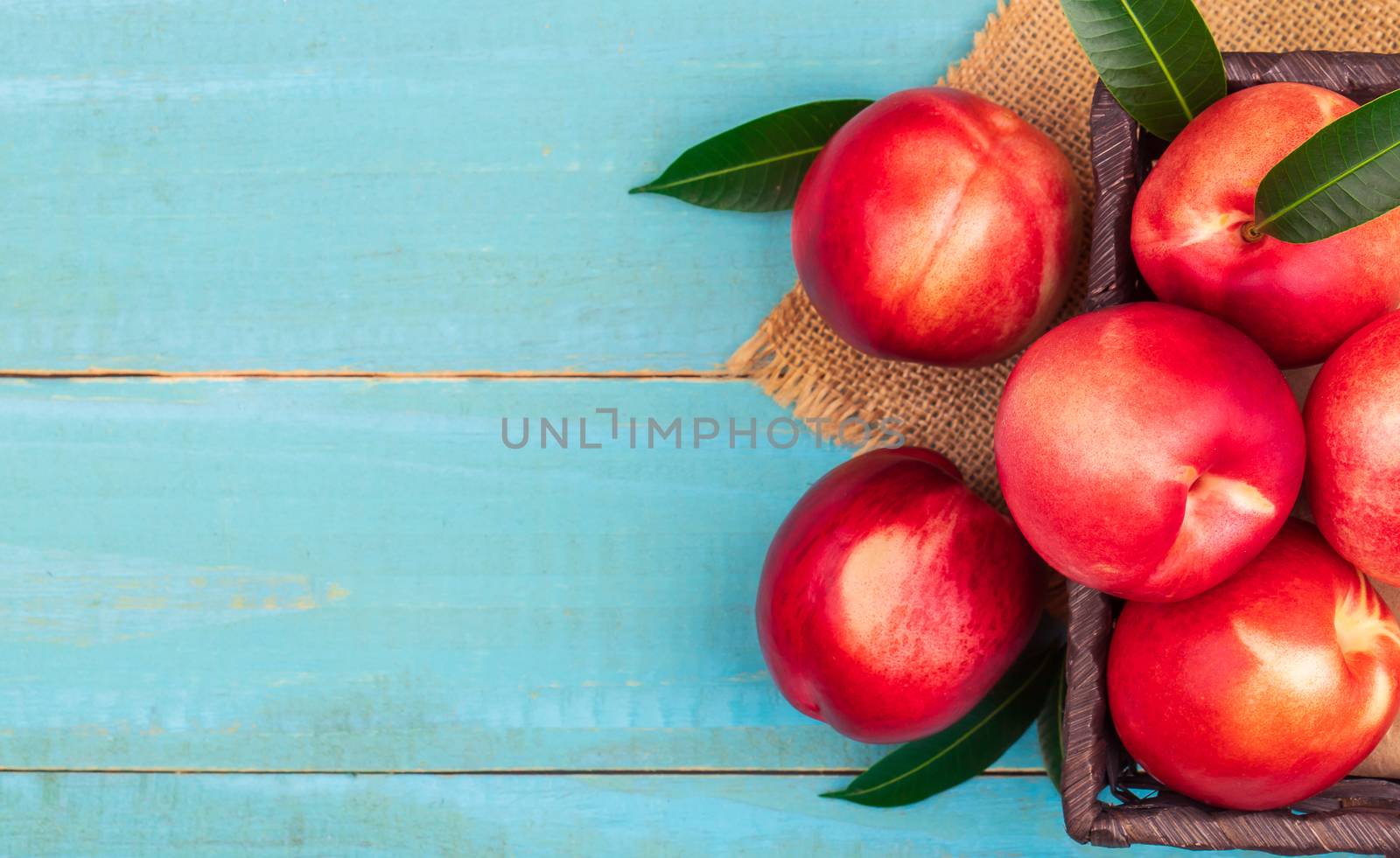 Sweet nectarine on wooden background by freedomnaruk