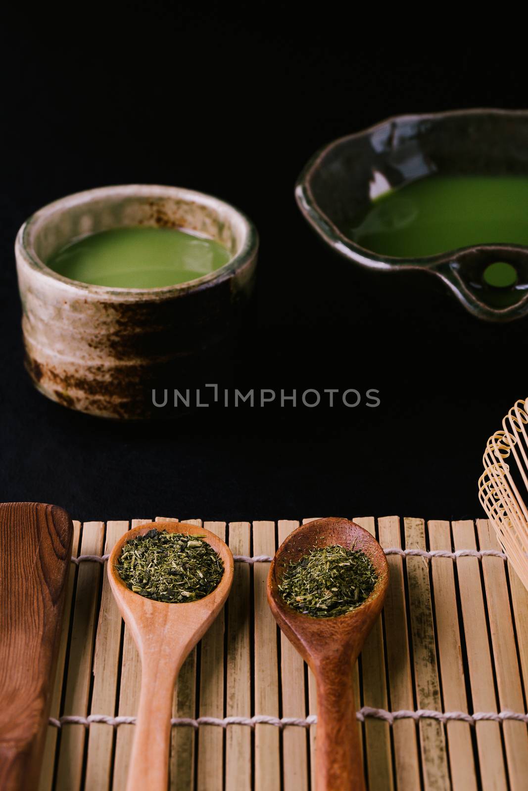 Top view of green tea matcha in a bowl on wooden surface