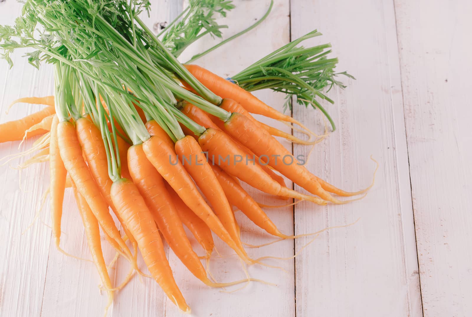 Fresh and sweet carrot on a grey wooden table by freedomnaruk