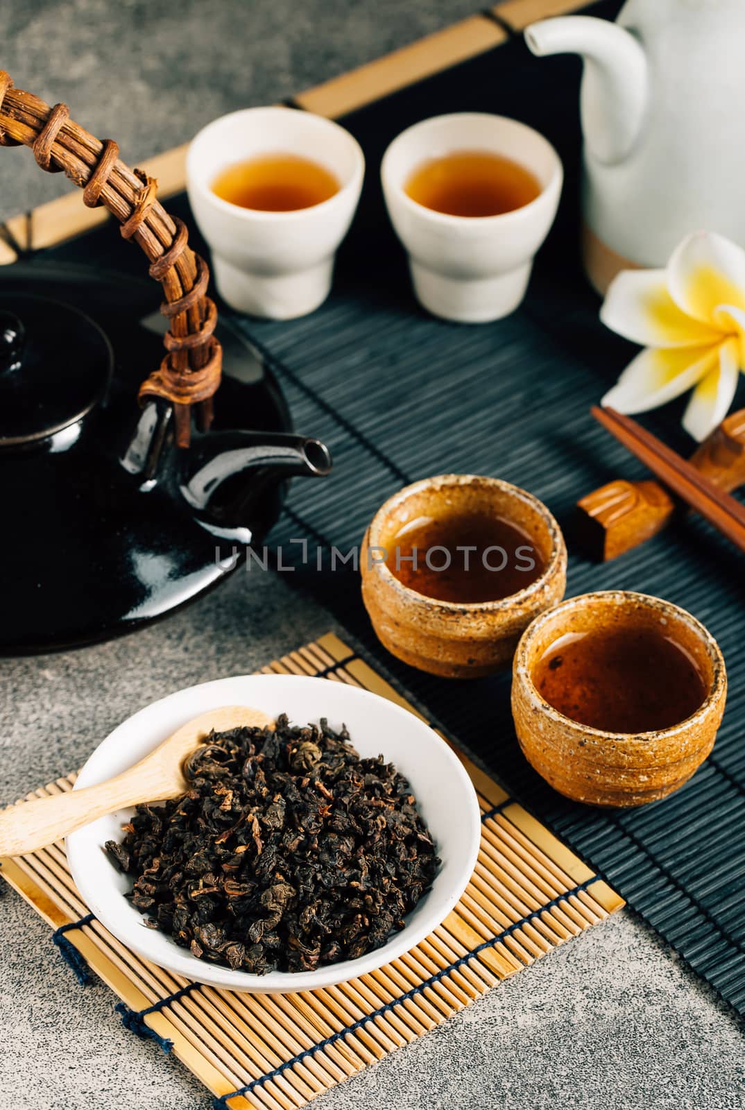 Hot tea in glass teapot and cup with steam