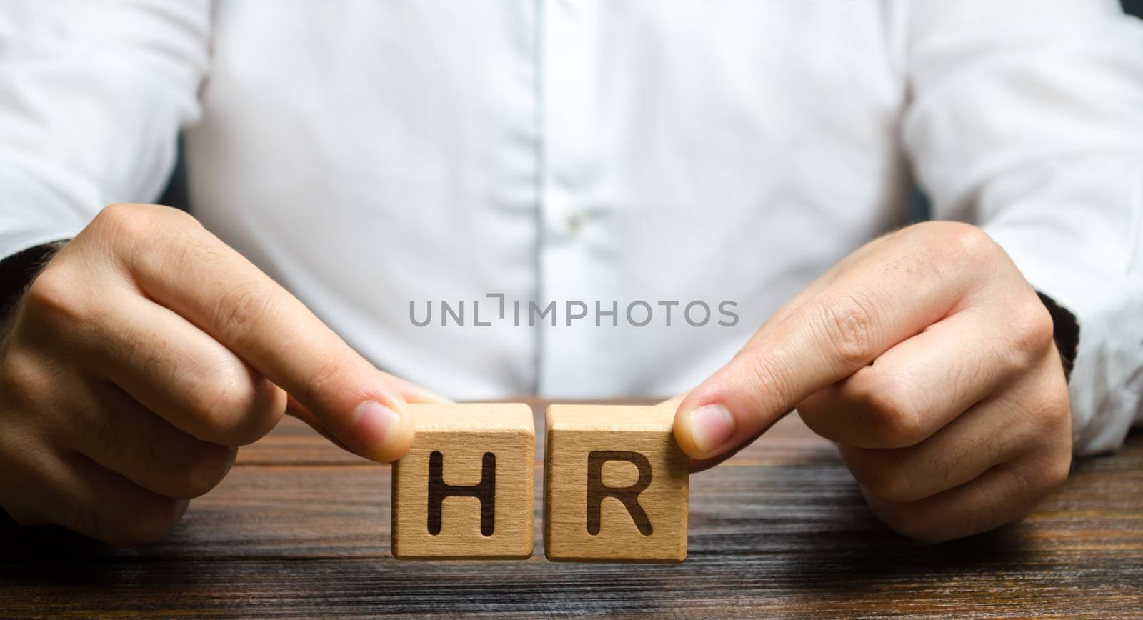 Businessman holds two blocks with HR. Recruiting new workers, headhunters Human resources. Search for talented worker. Assessment of qualities skills. Attraction of valuable personnel to the company