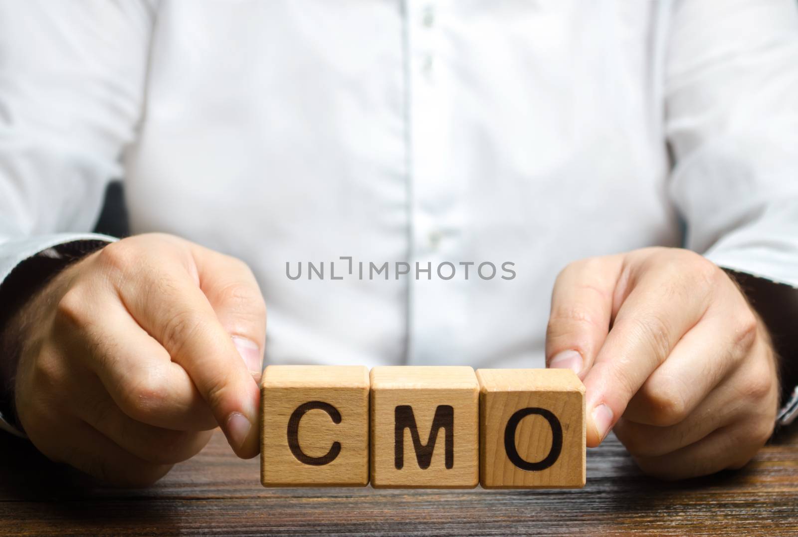 Man holds abbreviation CMO. Marketing strategy of the company. Post top manager Chief Marketing Officer. PR and advertising, establishing public relations and the media