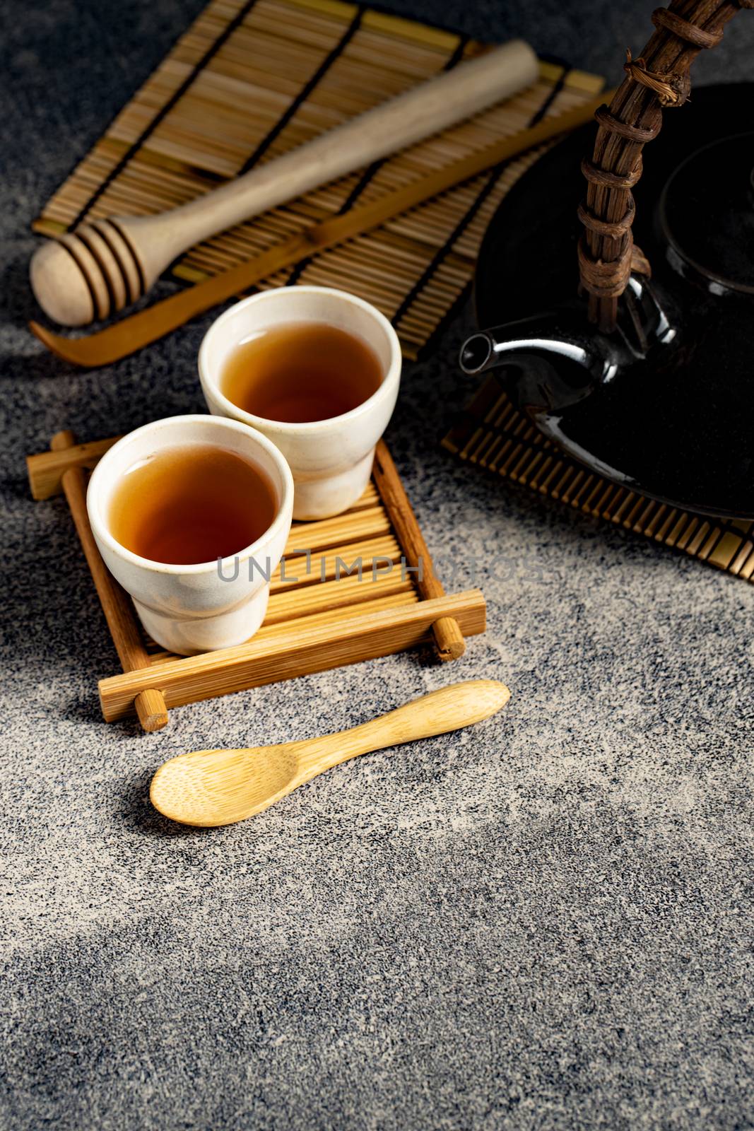 Hot tea in glass teapot and cup with steam