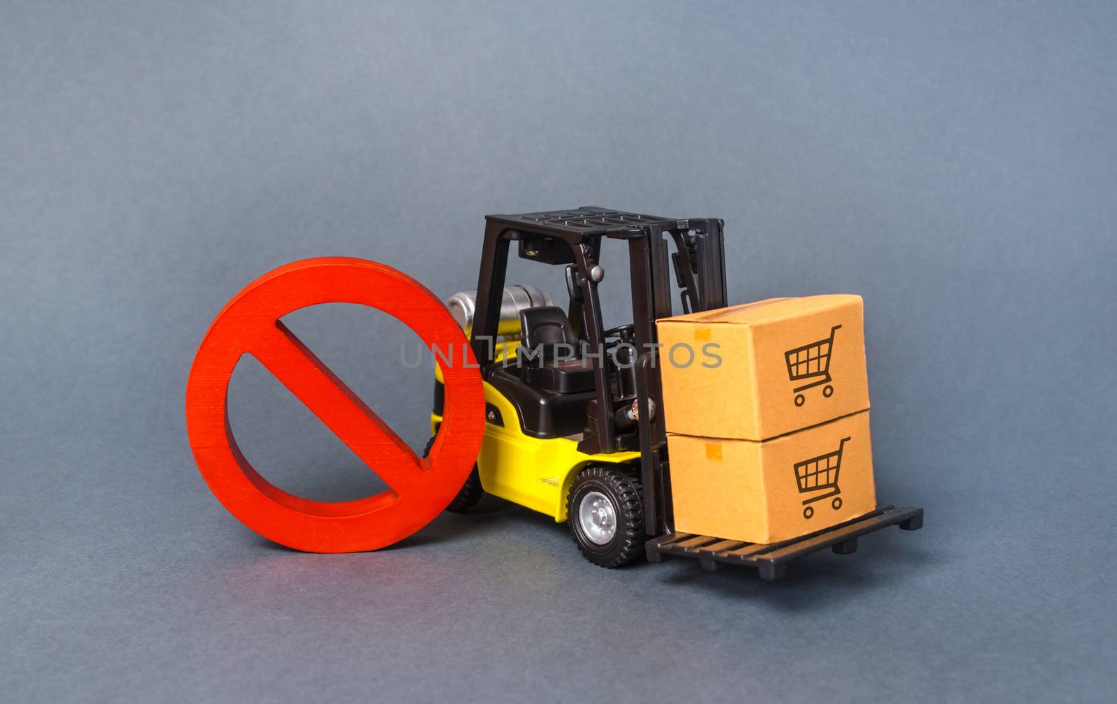Yellow Forklift truck carries boxex and a red prohibition symbol NO. Embargo trade wars. Restriction on importation production, ban on export of dual-use goods to countries under sanctions by iLixe48