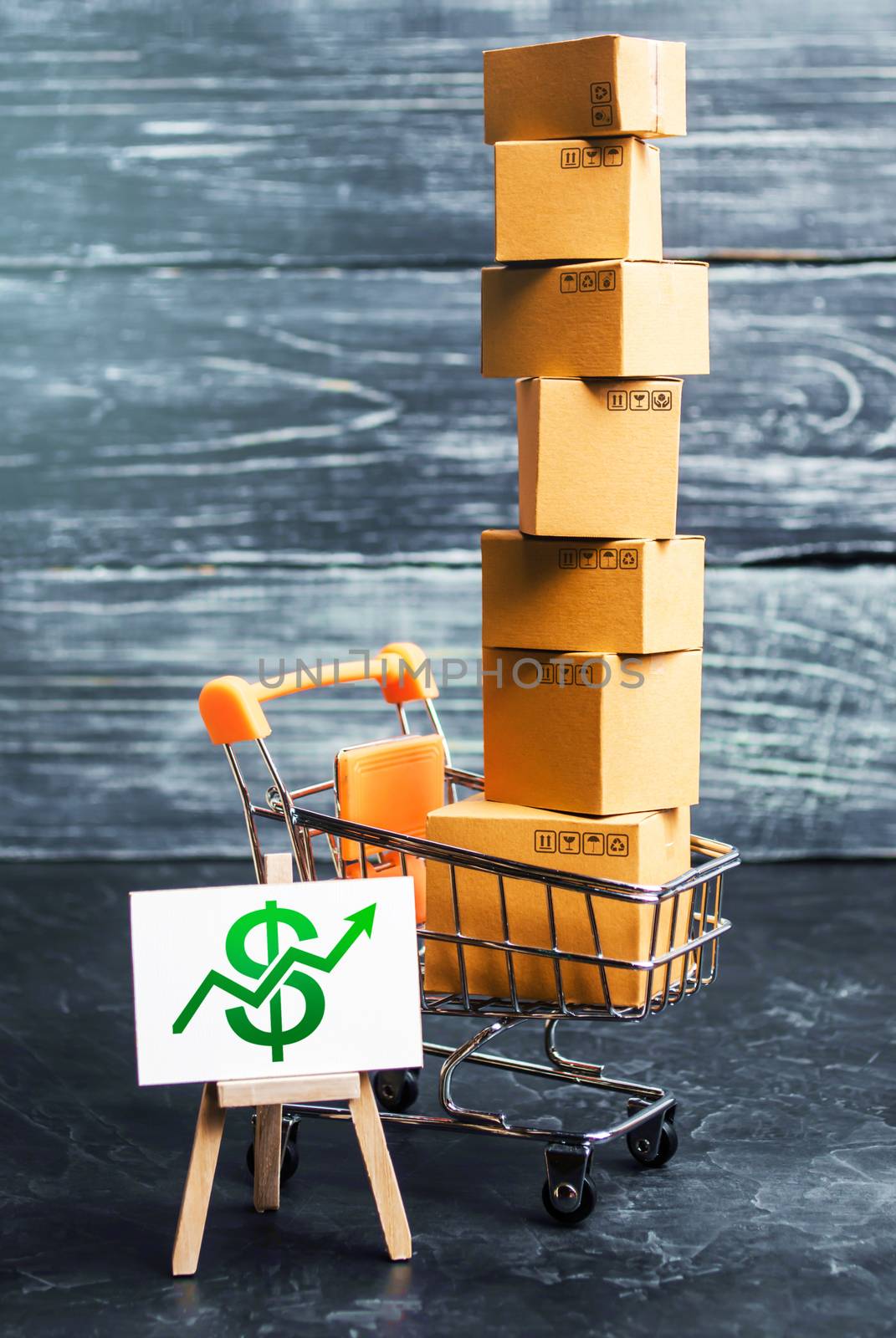 Shopping cart filled with boxes and a stand sign with a green dollar up arrow. shopping online. development of Internet network trade. E-commerce. sales of goods and services through online trading by iLixe48