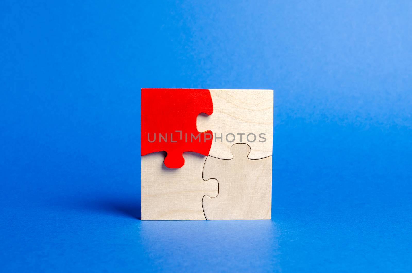 Wooden puzzles on a blue background. One puzzle is different. Individual opinion. Stand out from the crowd. Uniqueness. Divergent views. Different concepts to other people. Place for text. by iLixe48