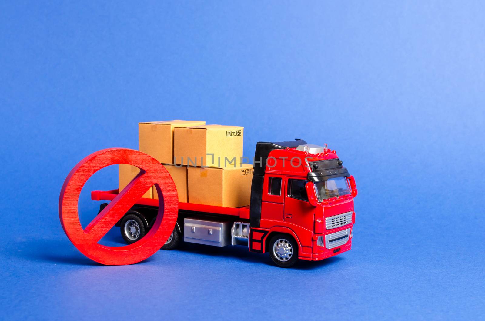 A red truck loaded with boxes and a red symbol NO. Embargo trade wars. Restriction on importation, ban on export of dual-use goods to countries under sanctions. transport companies. Ban on transit by iLixe48