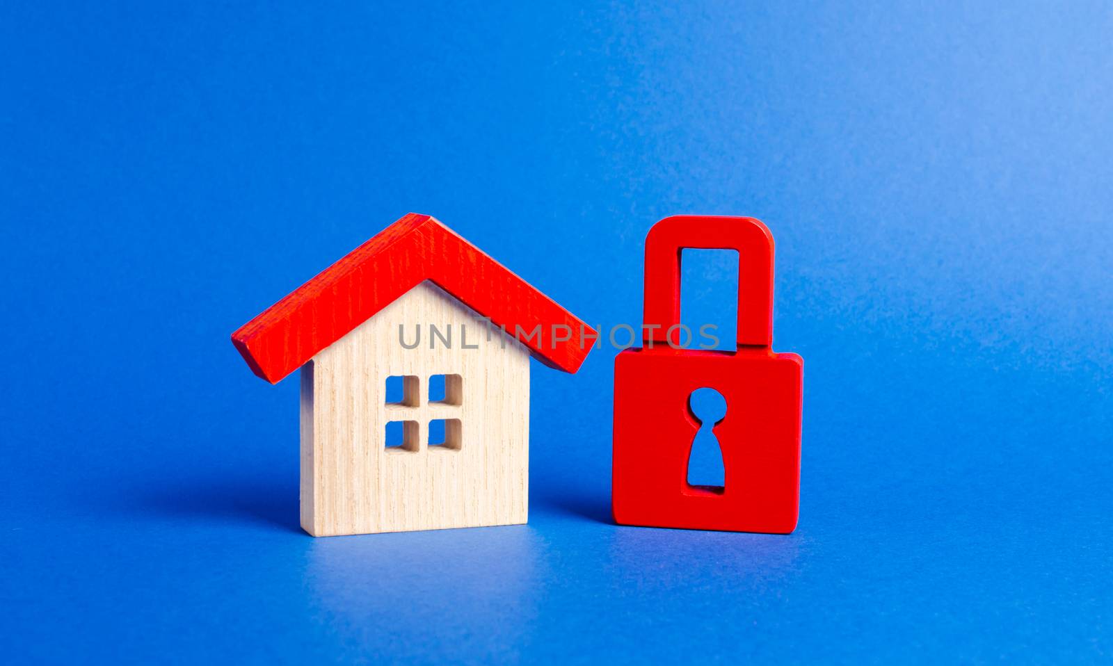 A wooden house and a red padlock. Unavailable and expensive real estate. house Insurance. Security and safety. Confiscation for debts. alarm system. seizure of property. Protection of property rights. by iLixe48