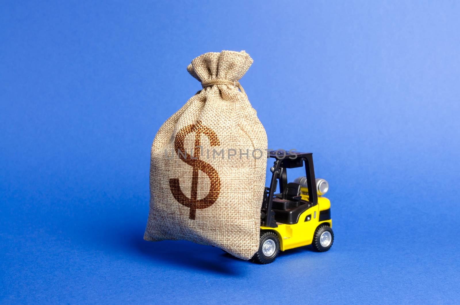 Yellow forklift truck carries a big bag of money. Attracting investment in the development and modernization of production and business projects. Revenue, profit, sales. super profit. copy space