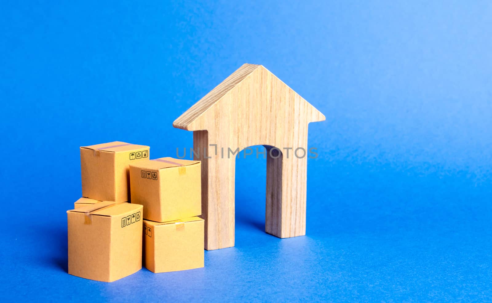 Residential house and pile of boxes. Concept of moving to another house or city. beginning of a new stage of life. Property transportation. Freight shipping, goods delivery and installation