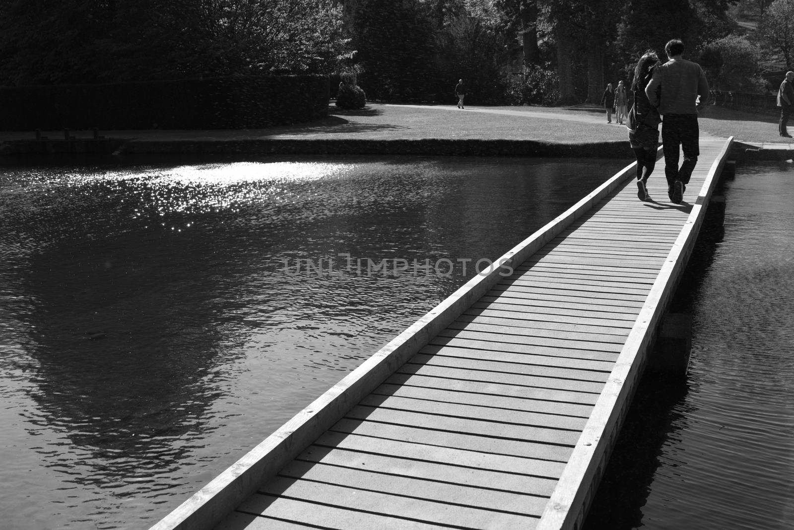 A young couple walking along a low footbridge