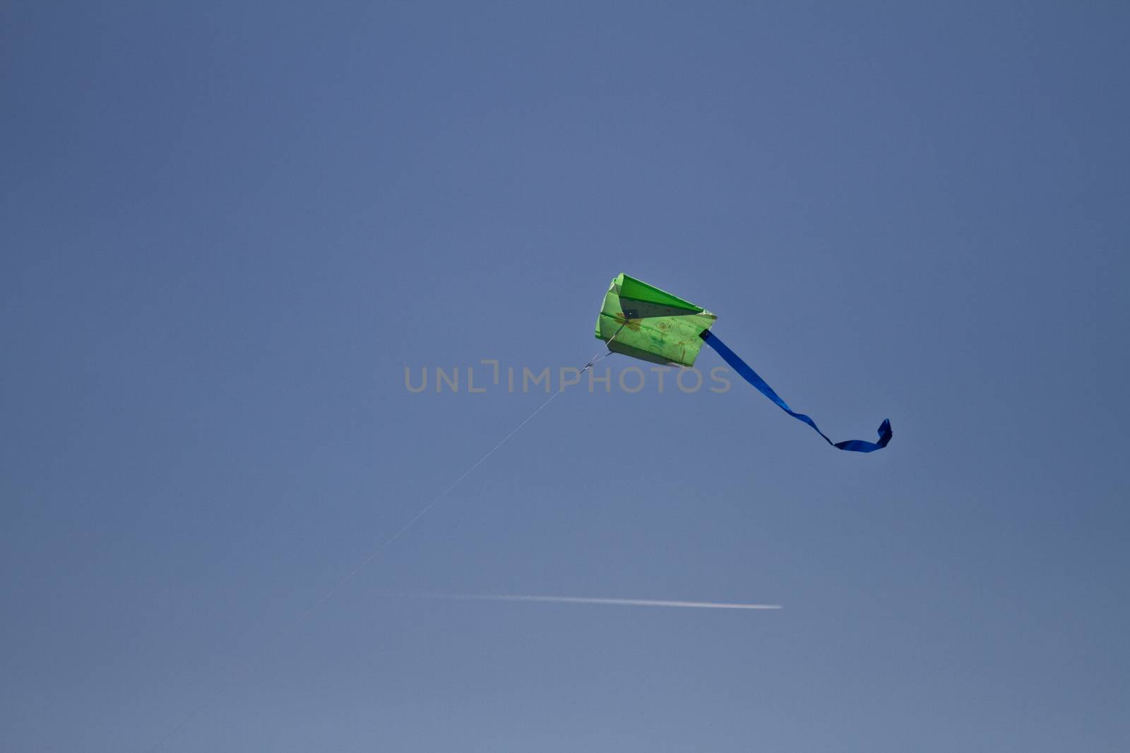 Flying a kite in the bright blue clear sky