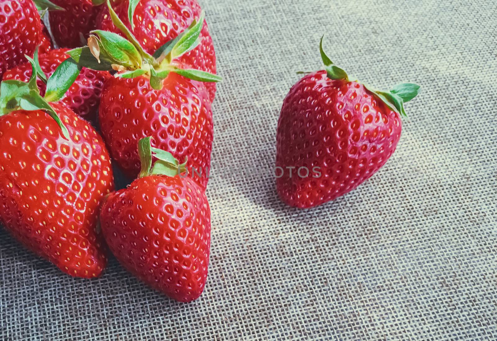 Organic strawberries on rustic linen background by Anneleven