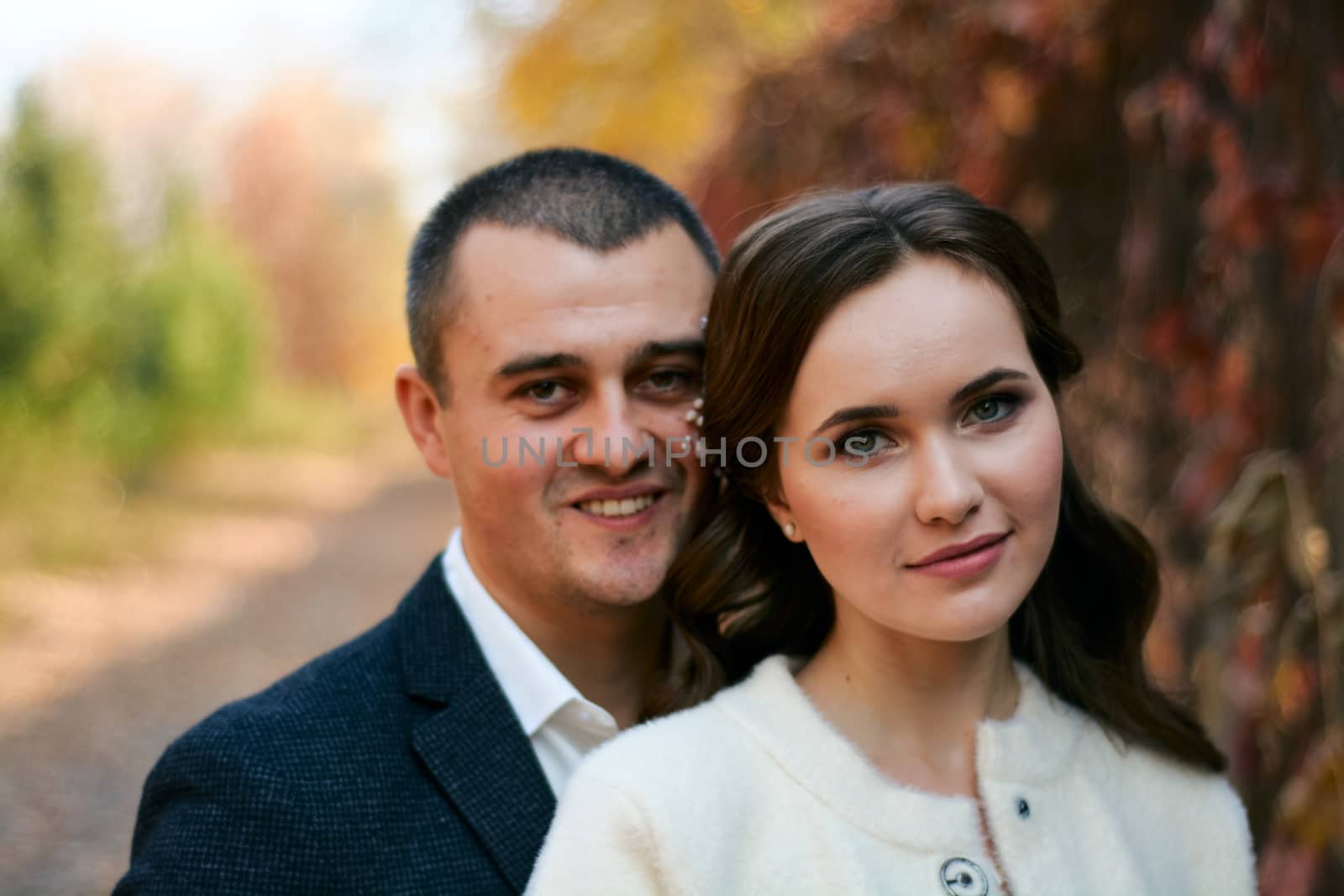 Couple in love close-up portrait. Young male and woman just married. Concept of happy family. Modern family outdoor.