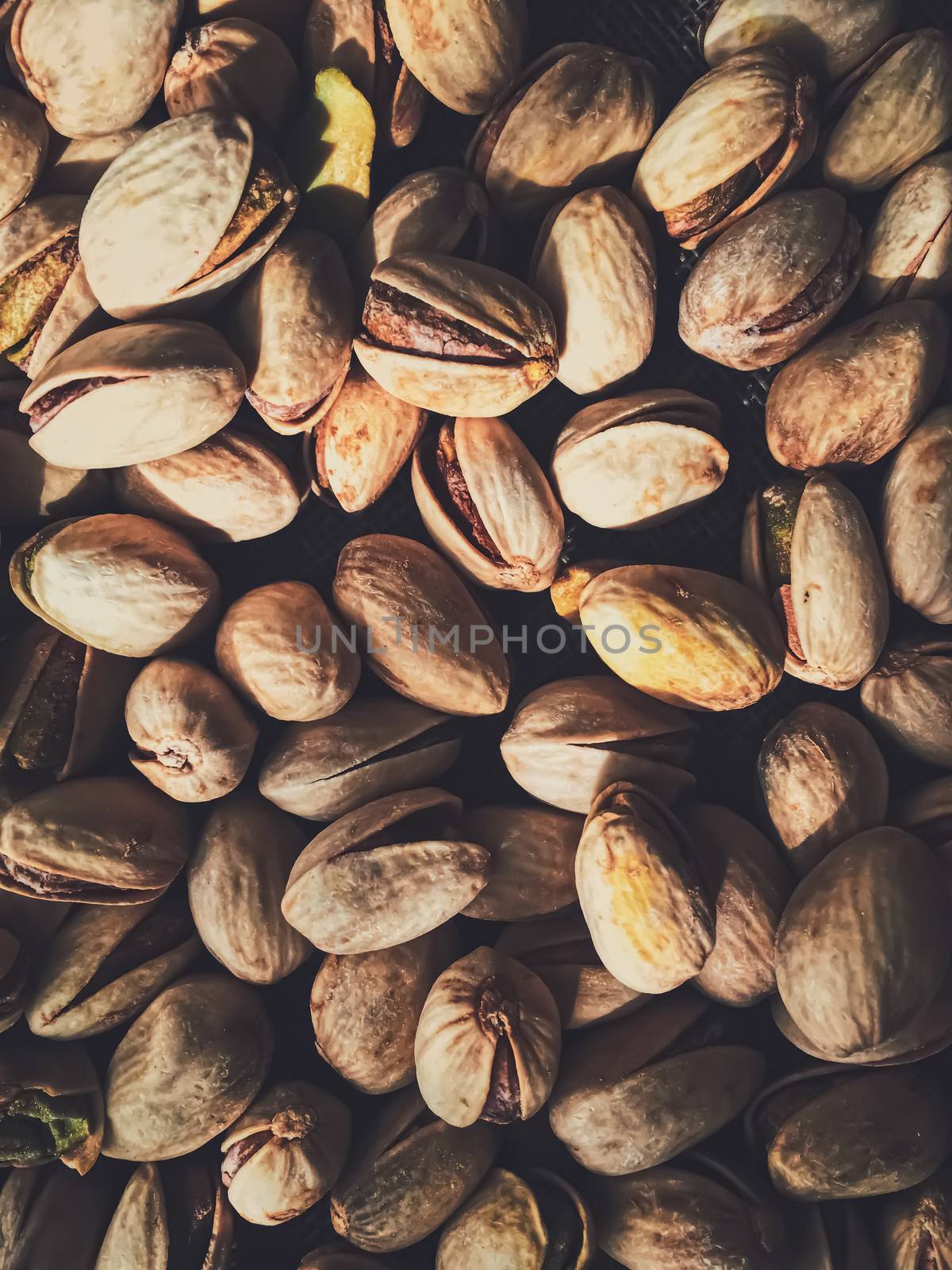 Pistachio nuts on rustic linen background by Anneleven