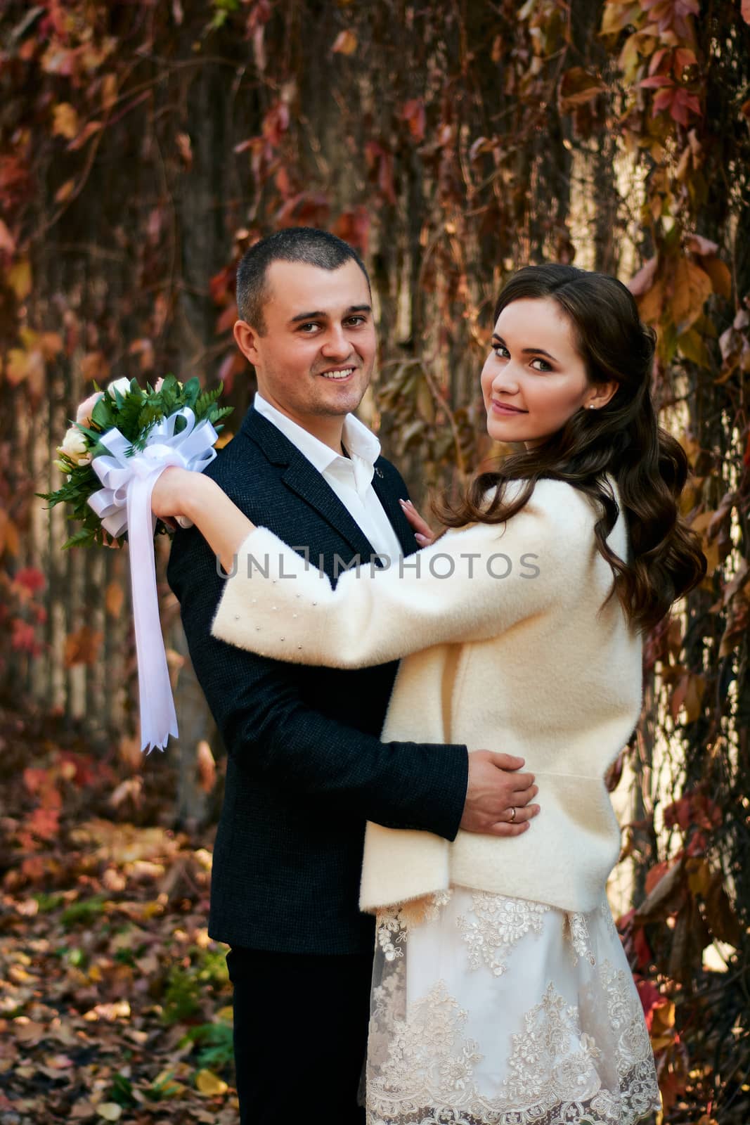 Couple in love close-up portrait. Young male and woman just married. Concept of happy family. Modern family outdoor. Adorable family demonstrate love and care. Autumn vacation.
