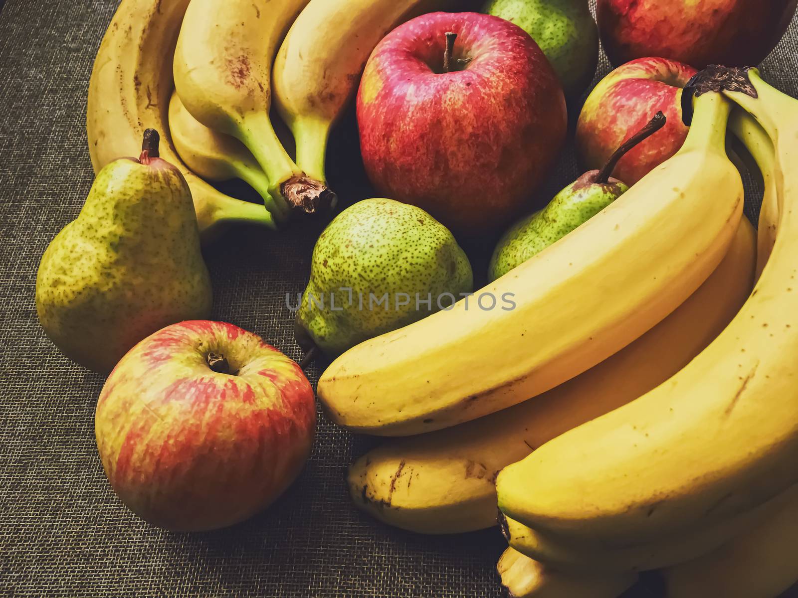 Organic apples, pears and bananas on rustic linen background, fruits farming and agriculture