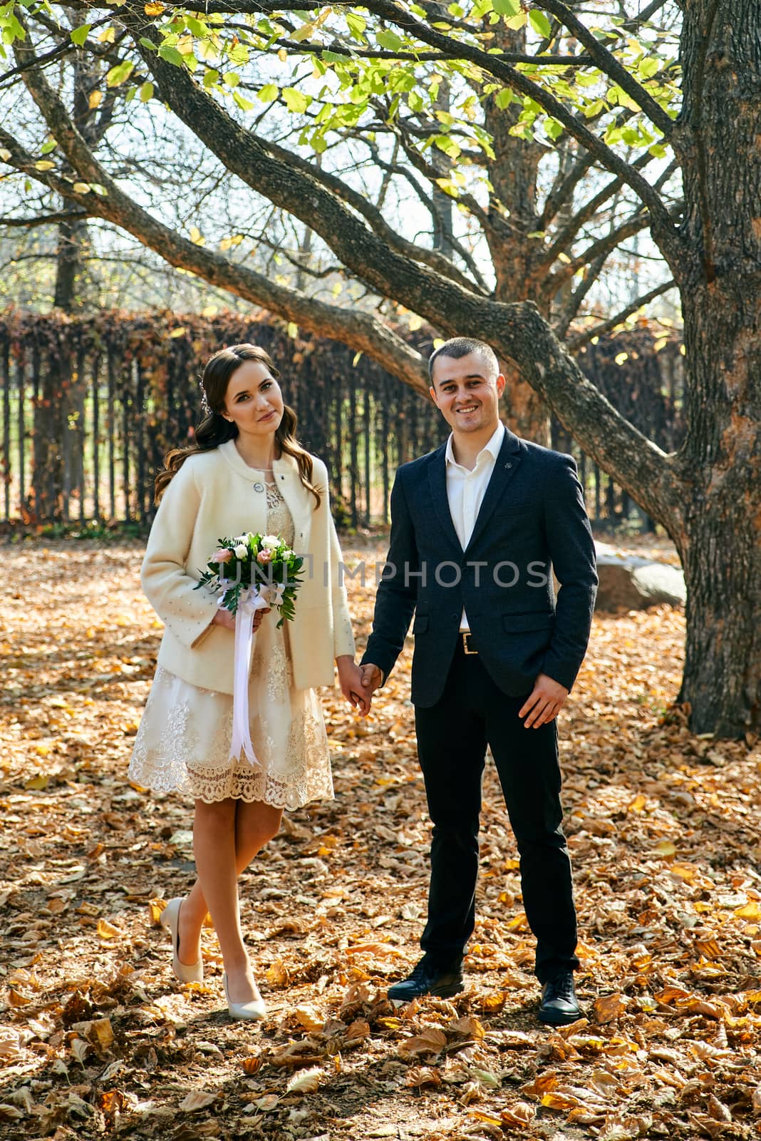 Couple in love close-up portrait. Young male and woman just married. Concept of happy family. Modern family outdoor. Adorable family demonstrate love and care. Autumn vacation.