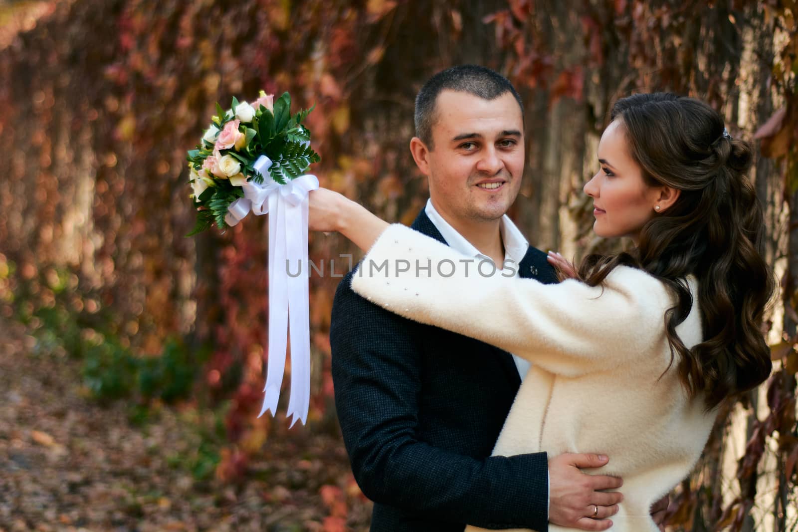 Couple in love close-up portrait. Young male and woman just married. Concept of happy family. Modern family outdoor. Adorable family demonstrate love and care. Autumn vacation.