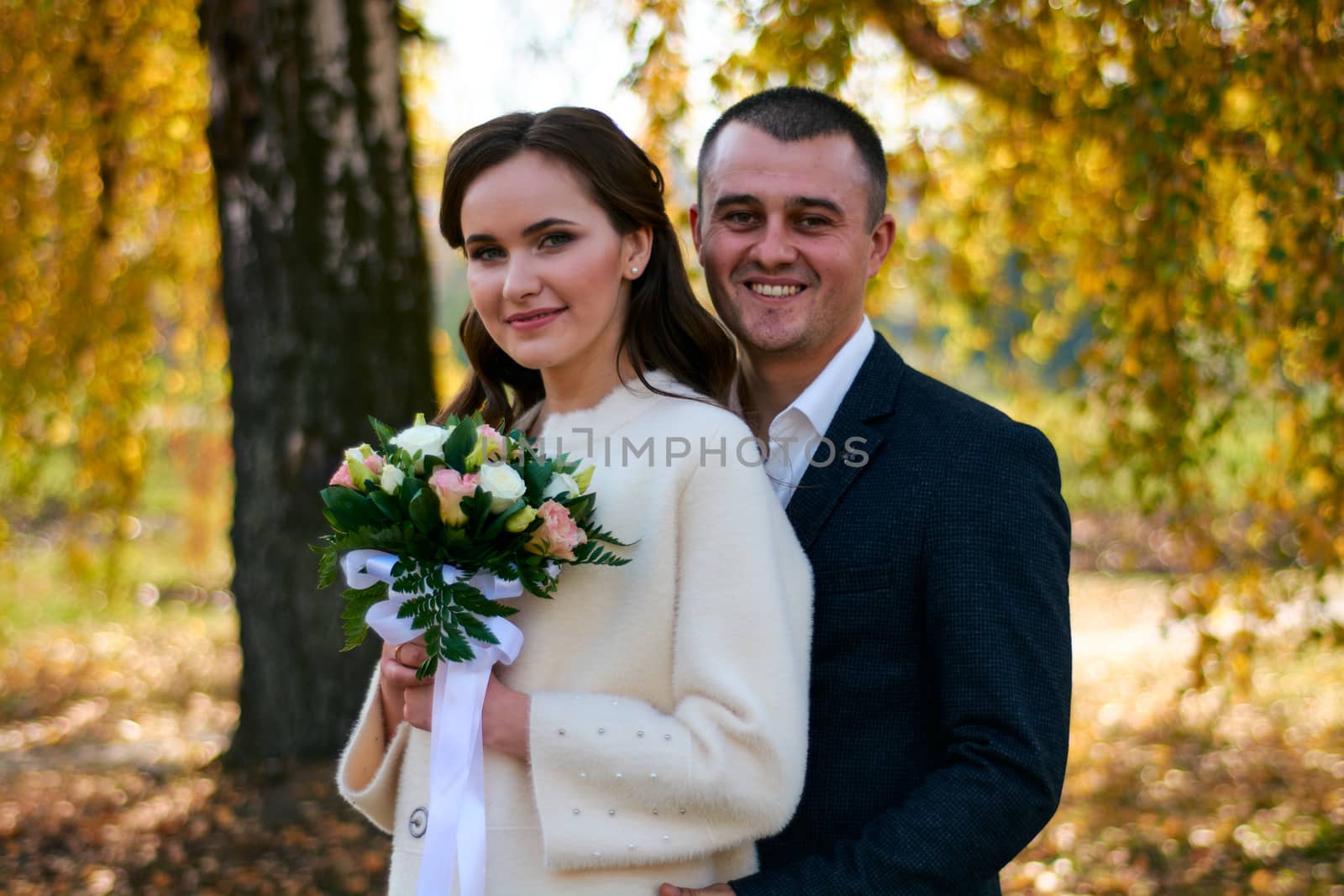 Couple in love close-up portrait. Young male and woman just married. Concept of happy family. Modern family outdoor. Adorable family demonstrate love and care. Autumn vacation.