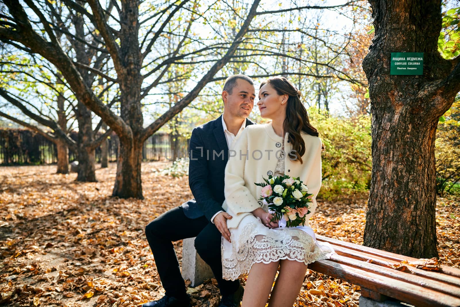 Couple in love close-up portrait. Young male and woman just married. Concept of happy family. Modern family outdoor. Adorable family demonstrate love and care. Autumn vacation.