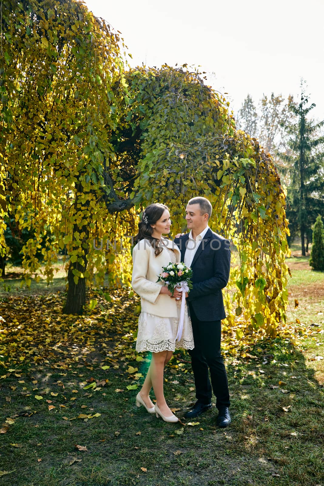 Couple in love close-up portrait. Young male and woman just married. Concept of happy family. Modern family outdoor. Adorable family demonstrate love and care. Autumn vacation.