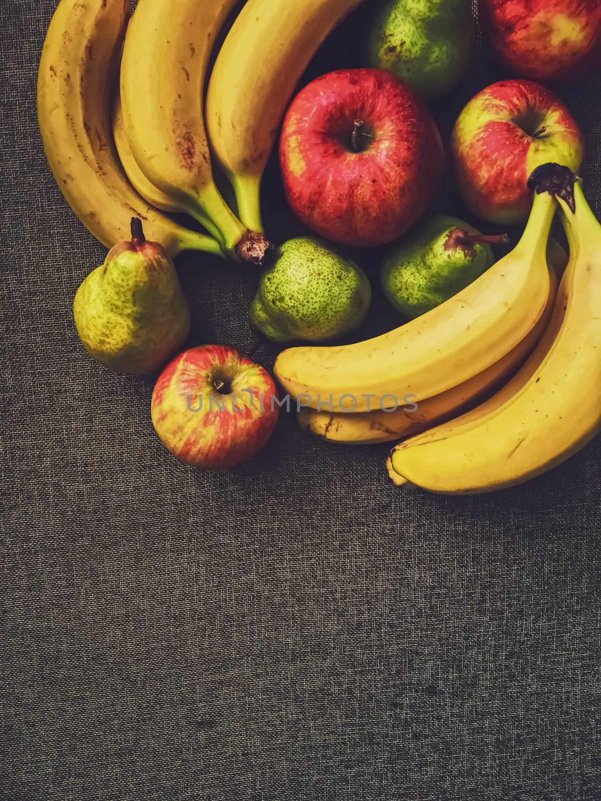 Organic apples, pears and bananas on rustic linen background, fruits farming and agriculture