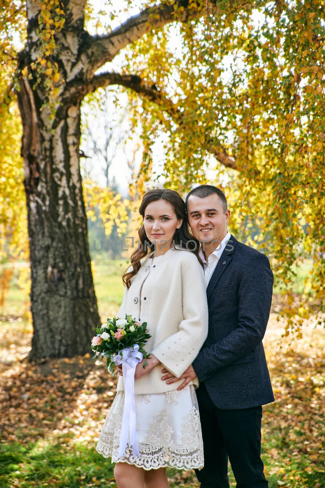 Couple in love close-up portrait. Young male and woman just married. Concept of happy family. Modern family outdoor. Adorable family demonstrate love and care. Autumn vacation.