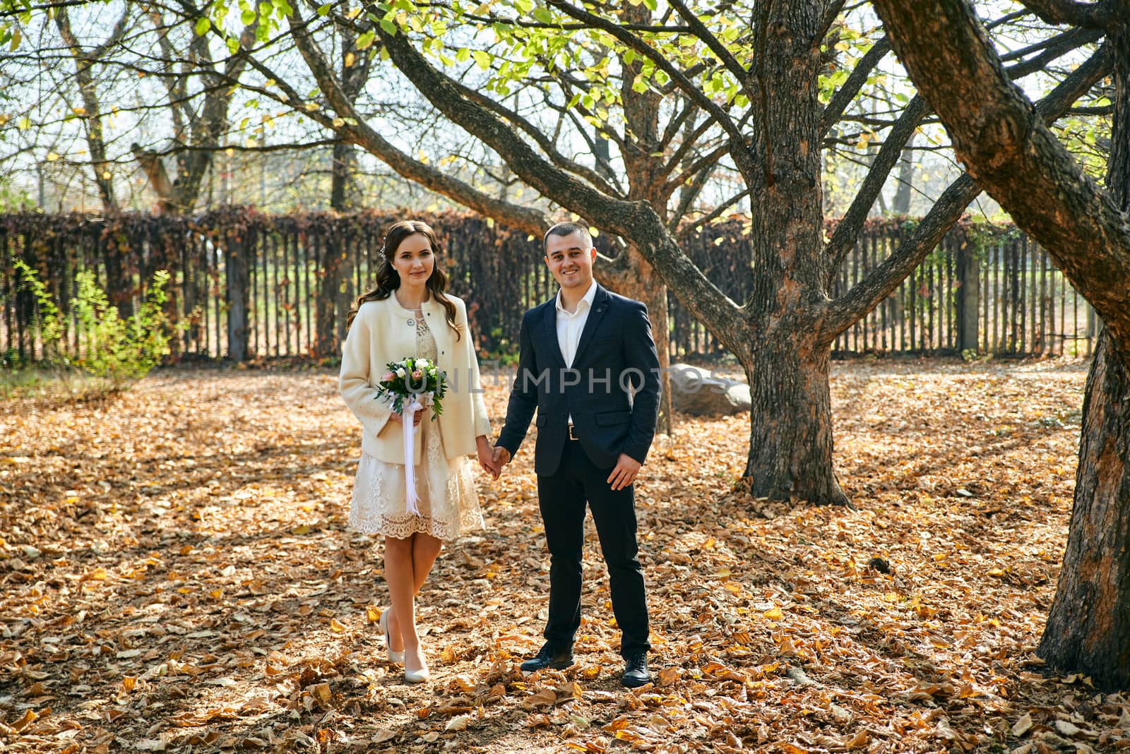 Couple in love close-up portrait. Young male and woman just married. Concept of happy family. Modern family outdoor. Adorable family demonstrate love and care. Autumn vacation.