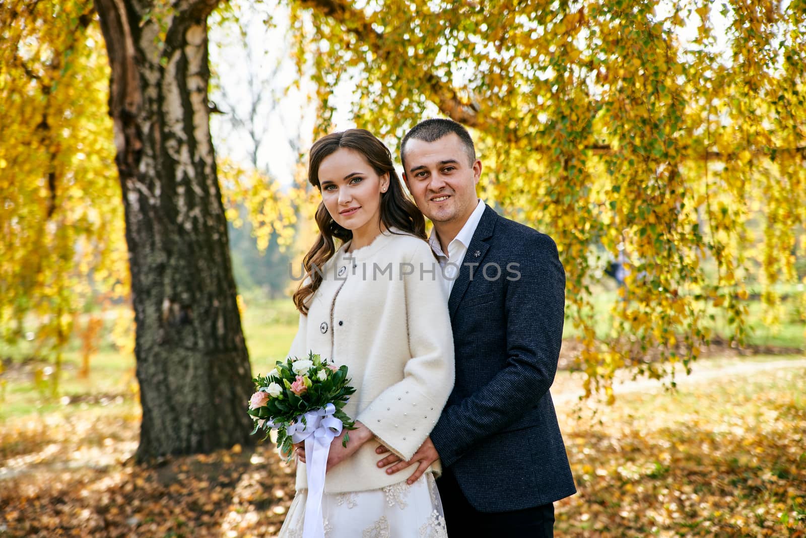 Couple in love close-up portrait. Young male and woman just married. Concept of happy family. Modern family outdoor. Adorable family demonstrate love and care. Autumn vacation.