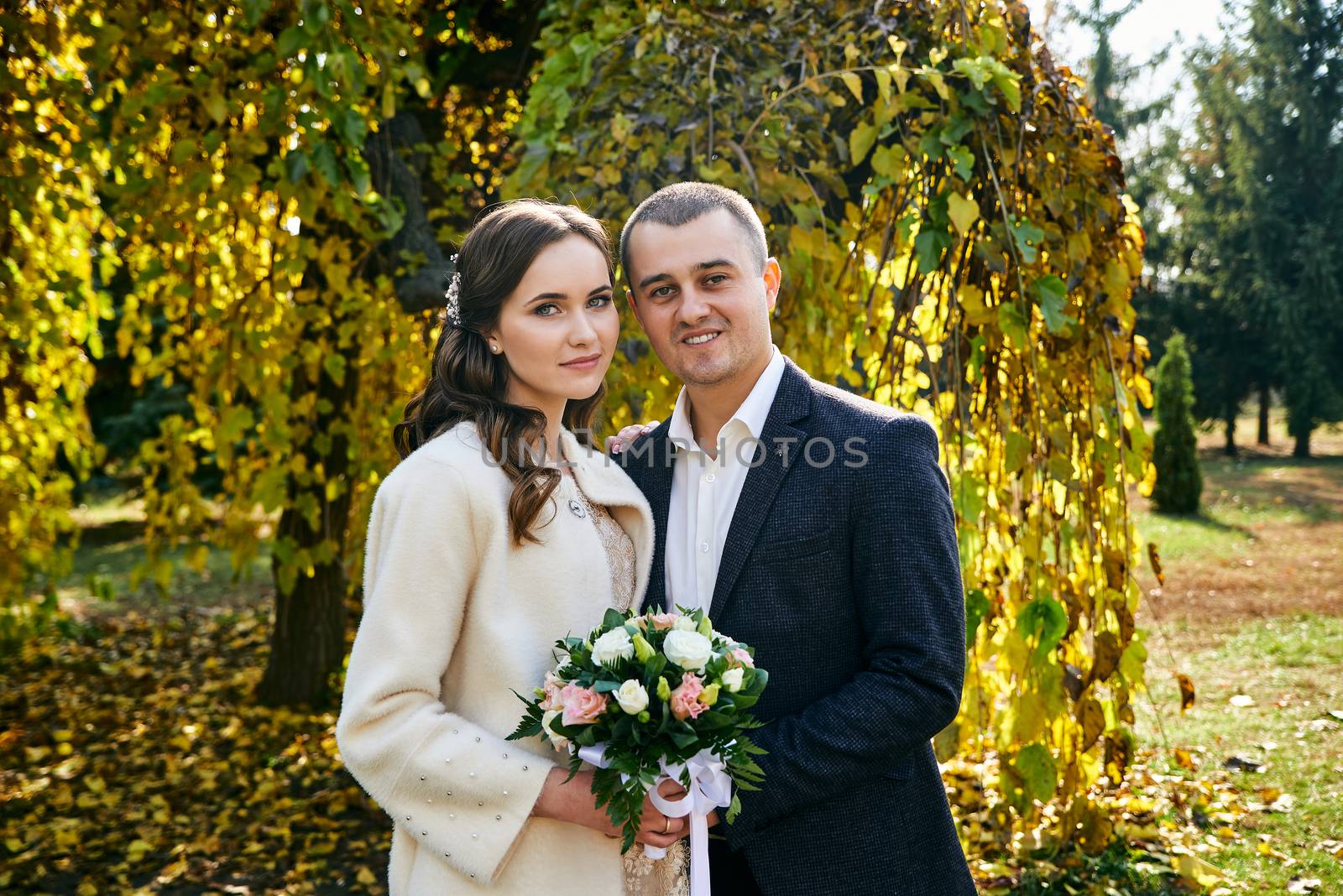 Couple in love close-up portrait. Young male and woman just married. Concept of happy family. Modern family outdoor. Adorable family demonstrate love and care. Autumn vacation.