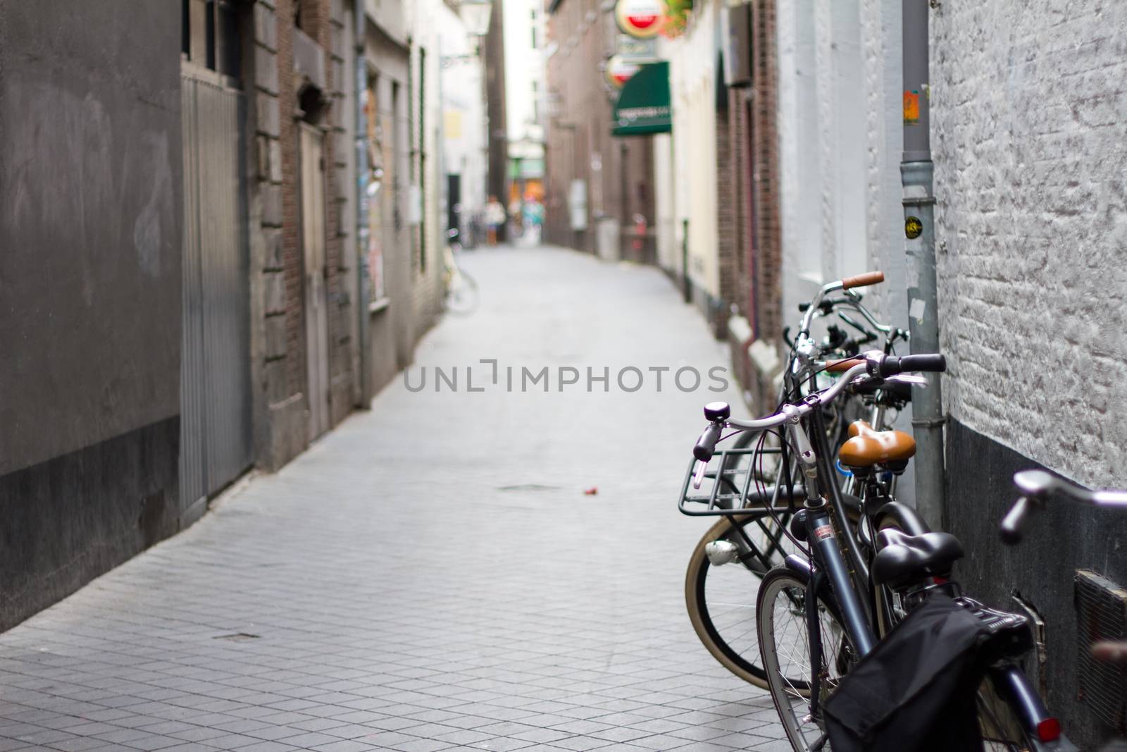 Some bicycles parked up at the side of a street