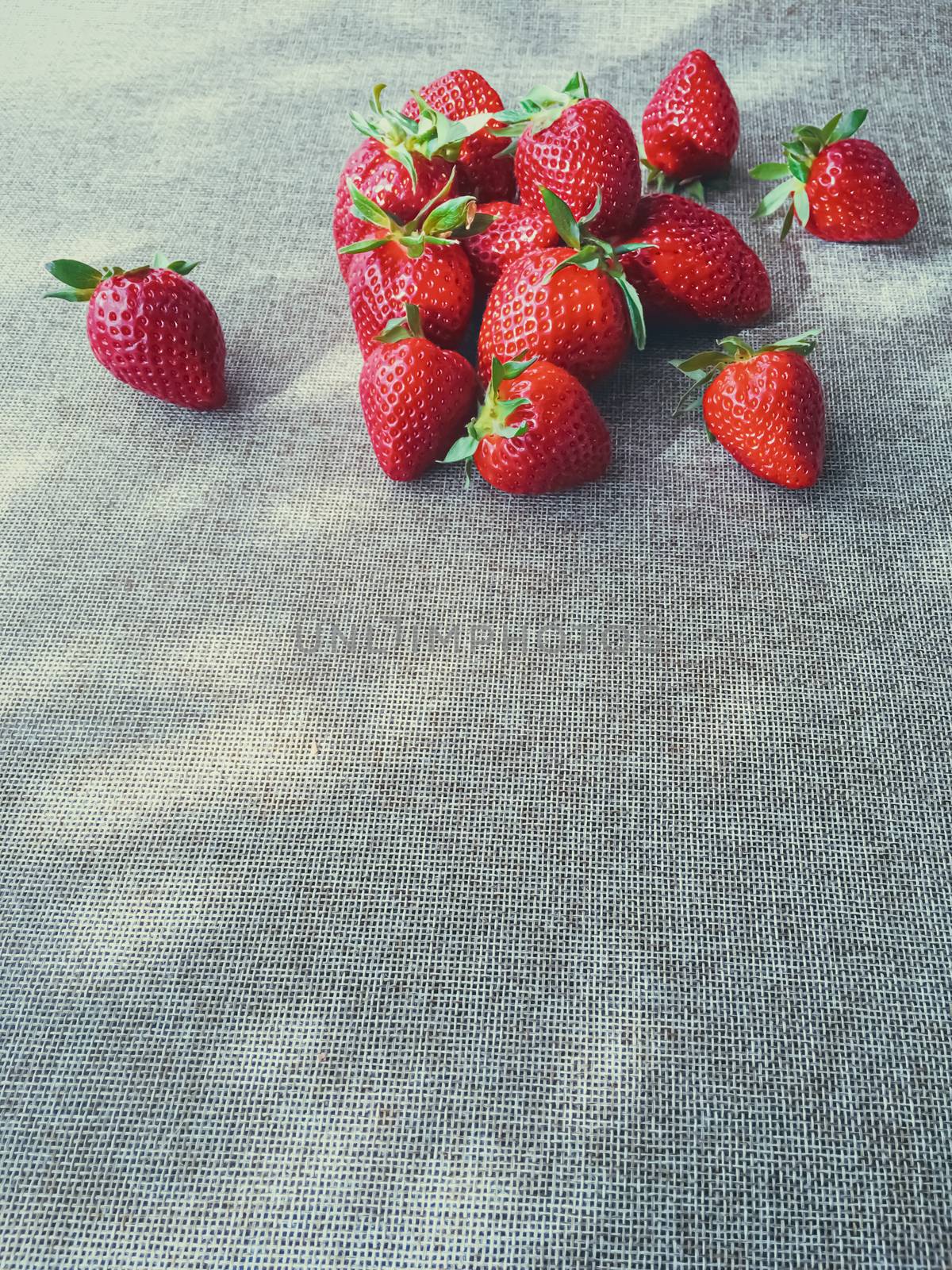 Organic strawberries on rustic linen background by Anneleven