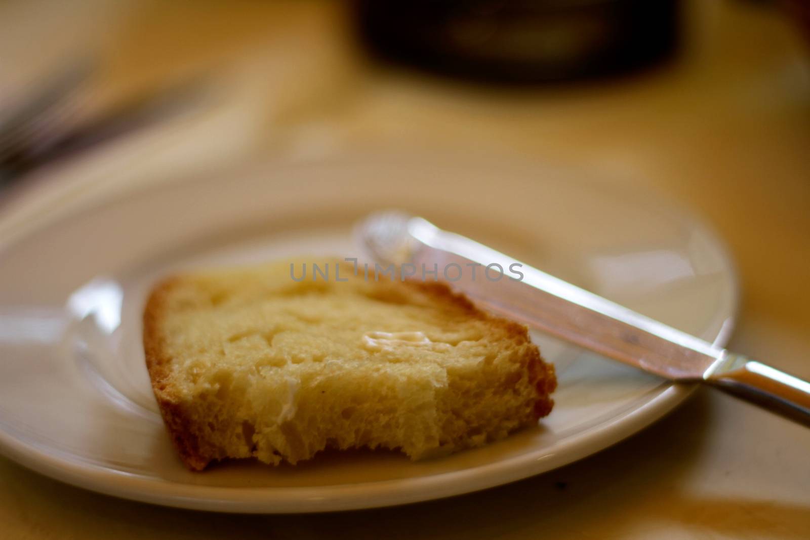 Bread and butter on a plate by samULvisuals