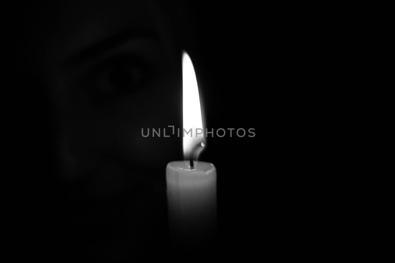 A Candle against a black background by samULvisuals