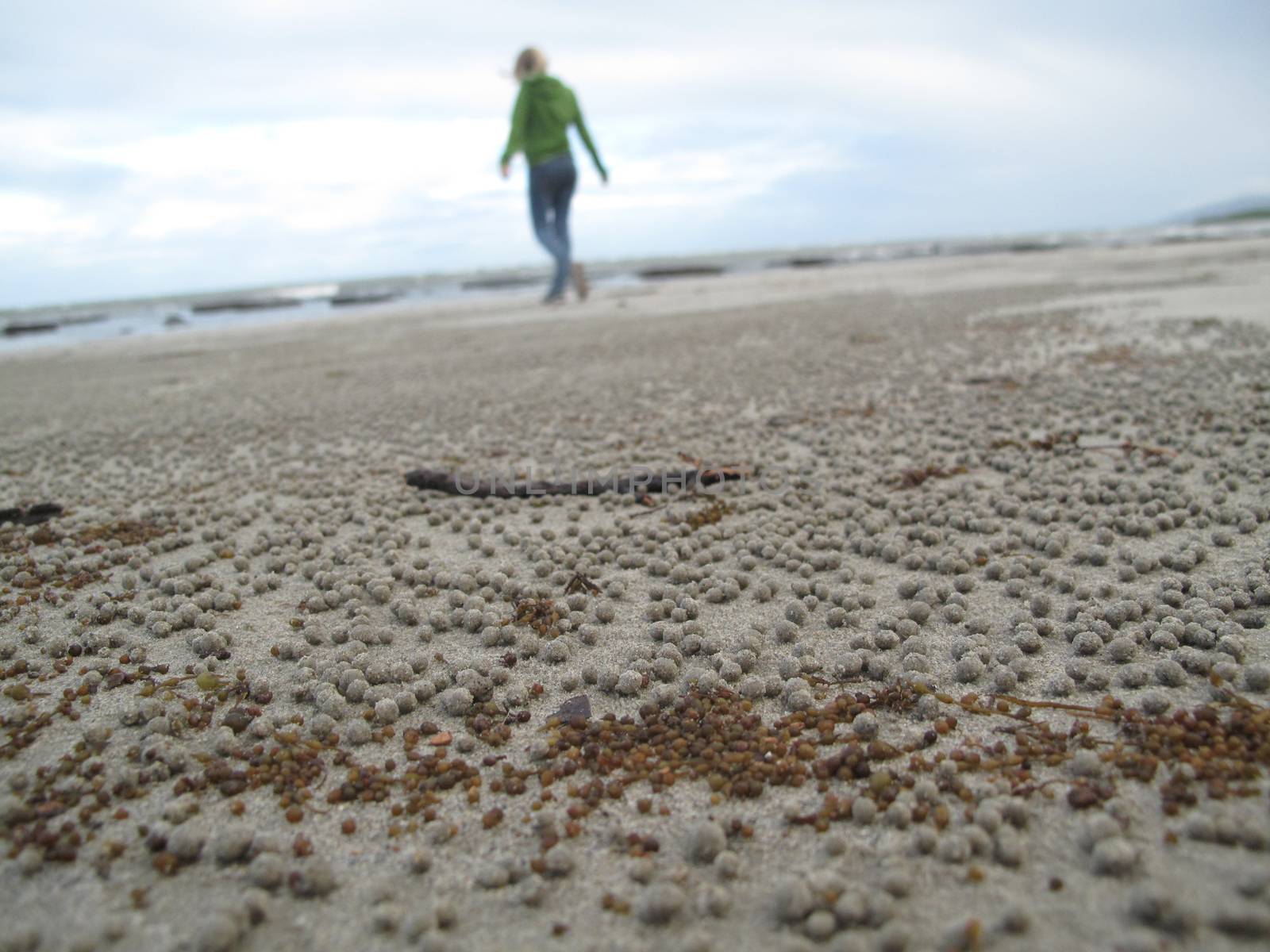 A woman walking in the sand by samULvisuals