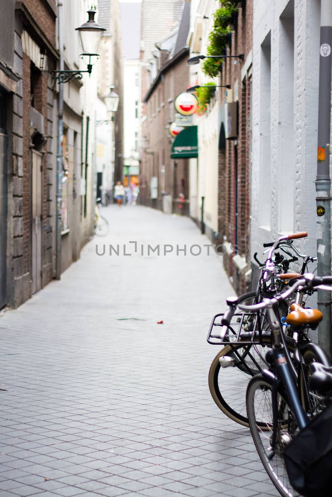 Some bicycles parked up at the side of a street