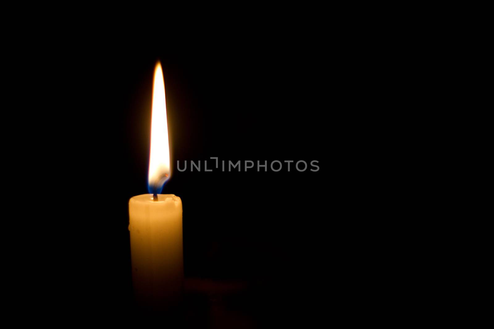 A Candle against a black background