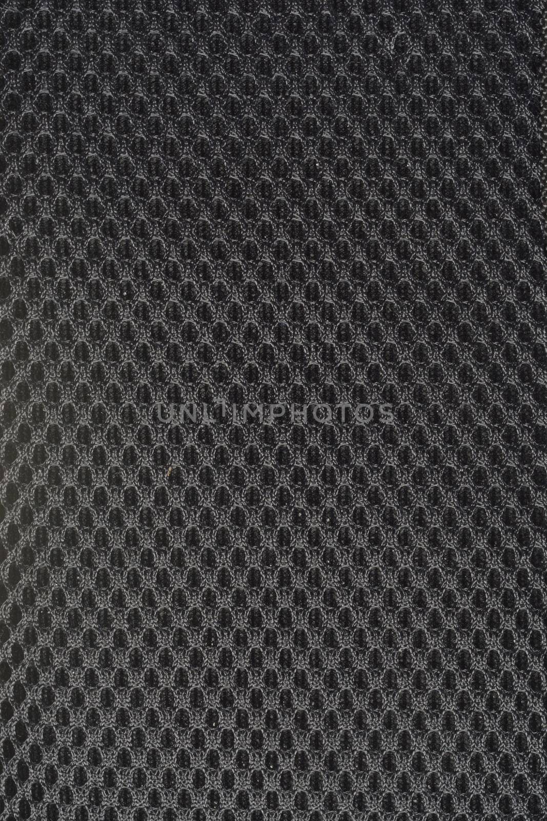 black gray fishnet cloth material as a texture background