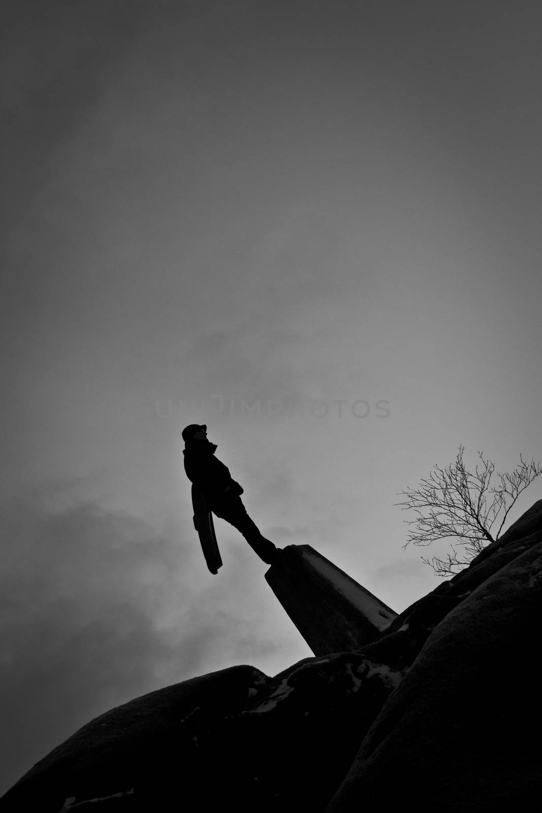 A super hero figure stood on a countryside hill at night