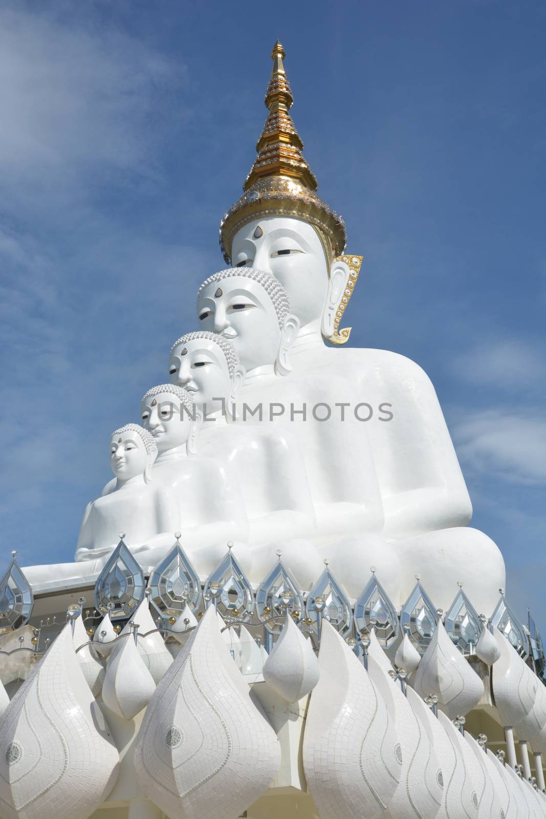 Five sitting Buddhas statue on blue sky, is a Buddhist monastery and temple in Phetchabun, Thailand. They are public domain or treasure of Buddhism, no restrict in copy or use

