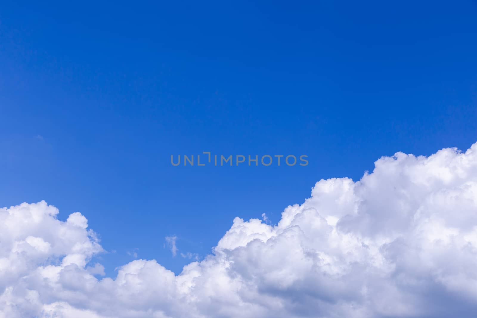 Blue sky background with white clouds on sunny day.