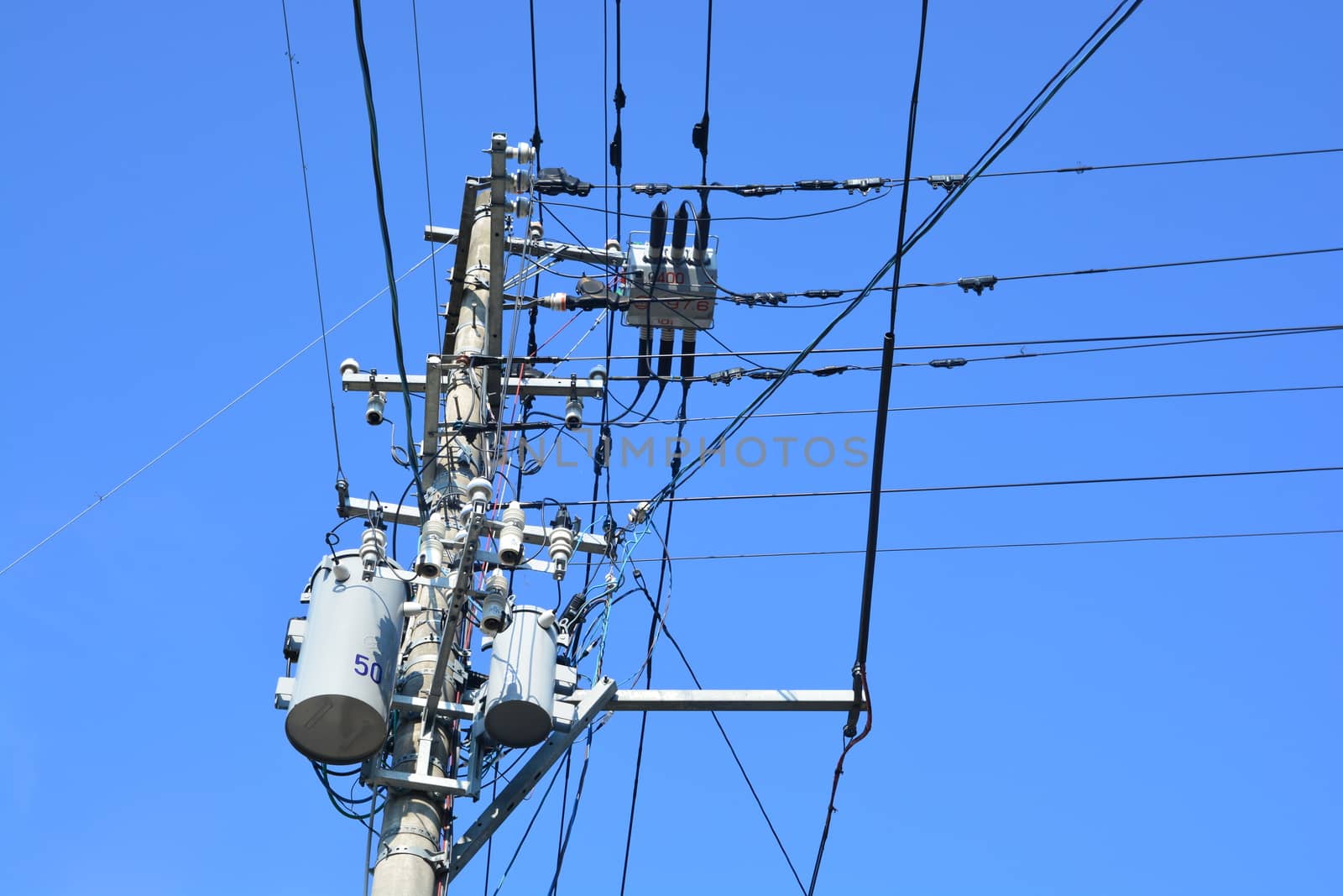 electricity transmission pylon against blue sky